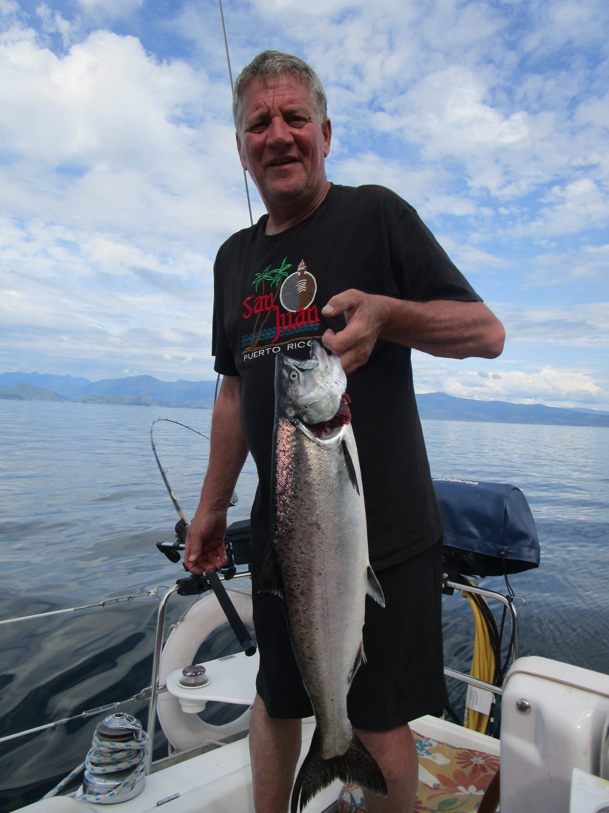 Todd holding a chinook salmon on the boat